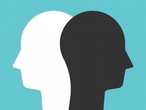 Two silhouettes of same head in white and black