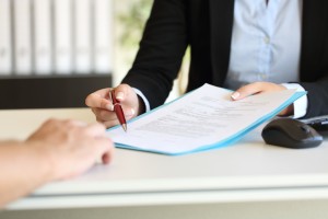 Person signing a business contract